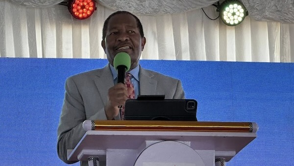 A person in a suit holding a microphone