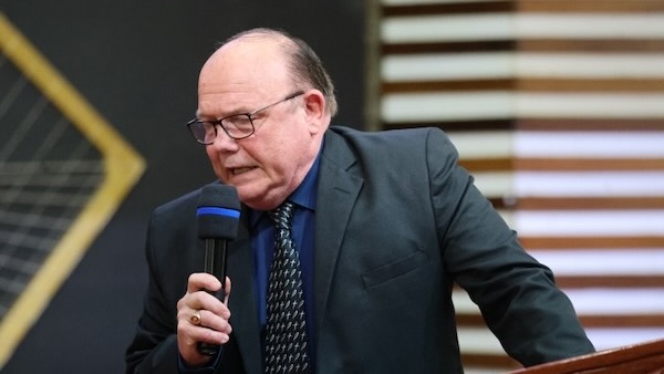 A person in a suit holding a microphone