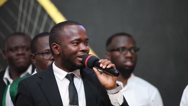 A person in a suit holding a microphone