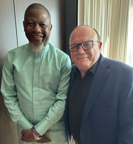 Two men standing together smiling