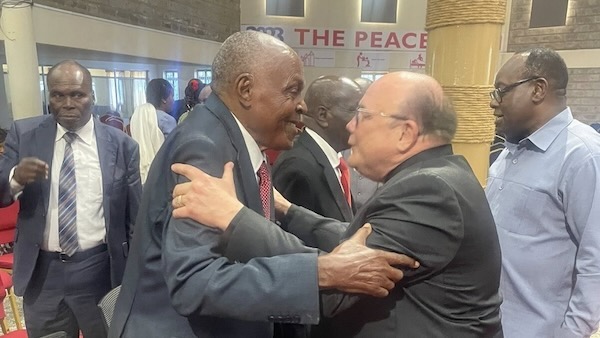 Two men in suits hugging