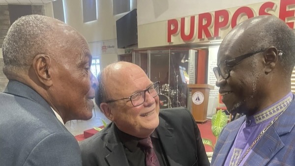 A group of men smiling