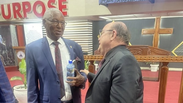 Two men in suits talking