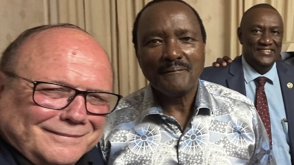 A person taking a selfie with another person