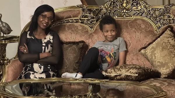 A person and a child sitting on a couch