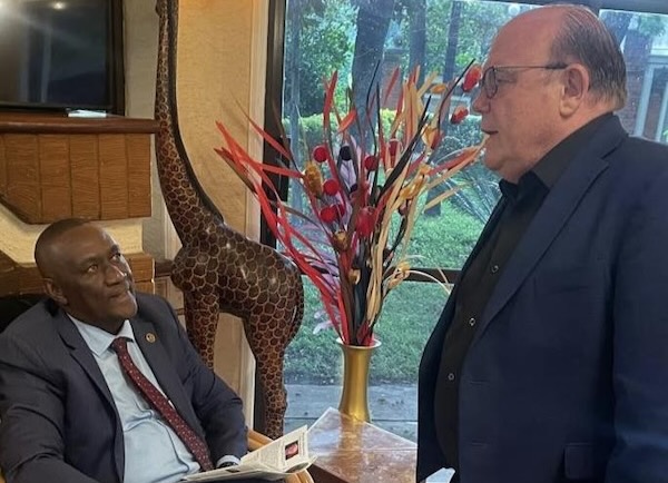 Two men in suits sitting in a chair