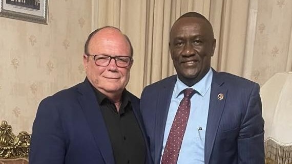 Two men standing together smiling