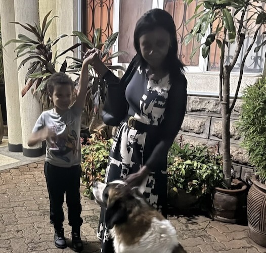 A person and a child with a dog