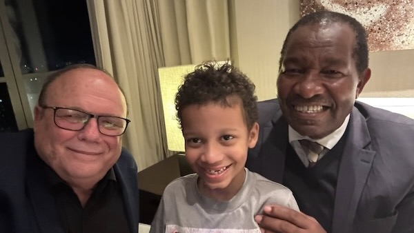 A group of men smiling and taking a selfie