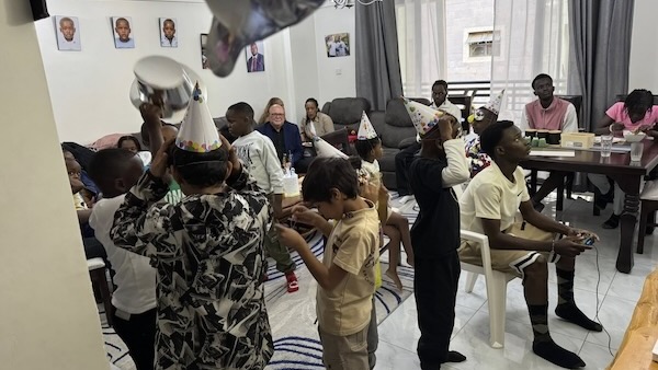 A group of people in a room with hats