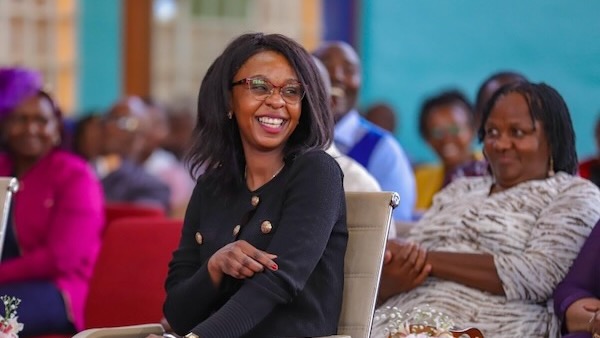 A person smiling at a group of people