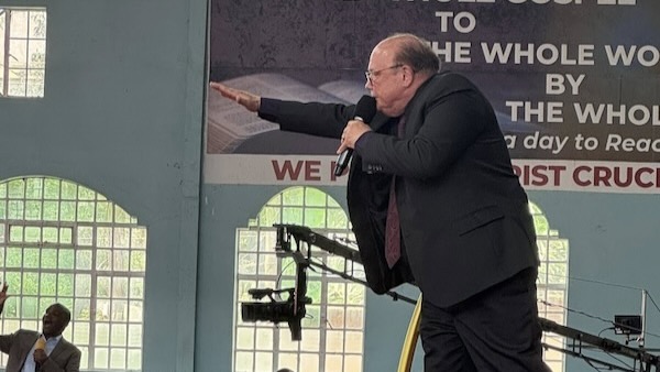 A person in a suit holding a microphone