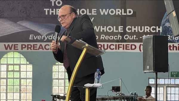 A person standing on a podium holding a microphone