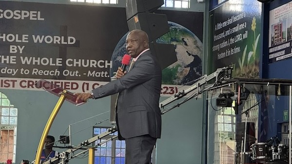 A person in a suit holding a microphone
