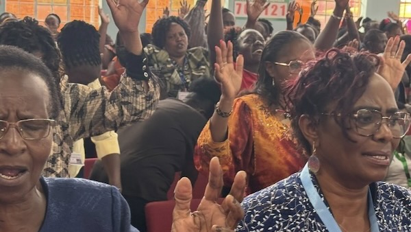 A group of people raising their hands