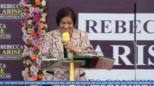 A person standing at a podium with a microphone