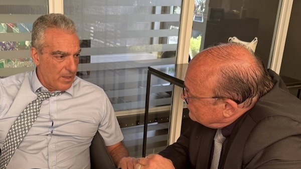 Two men shaking hands in a room
