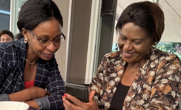 A couple of women looking at a device