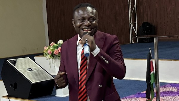 A person in a suit holding a microphone