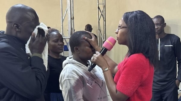 A person holding a microphone to a person