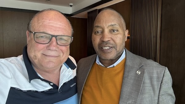 Two men standing together smiling