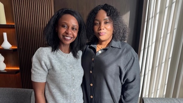 A couple of women standing together