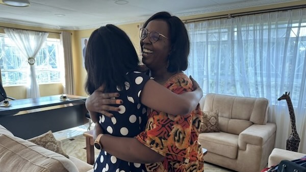 Two women hugging each other