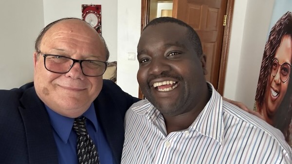 Two men smiling at the camera