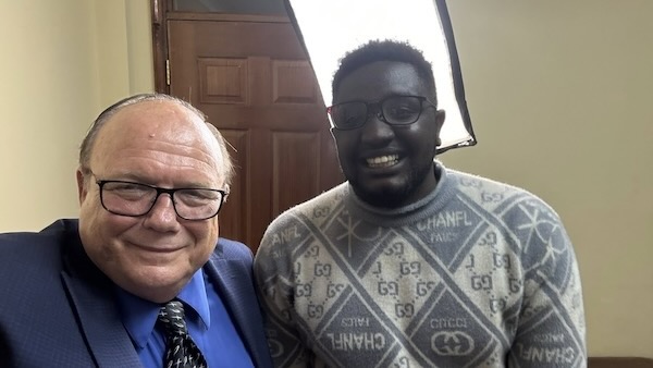 Two men smiling at the camera