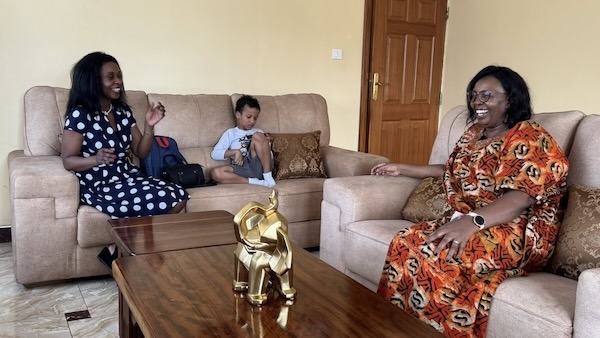 A person sitting on a couch with a child on the couch