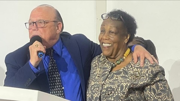 A person and person standing next to each other