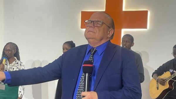 A person in a suit holding a microphone