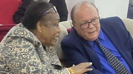 A person and person sitting together