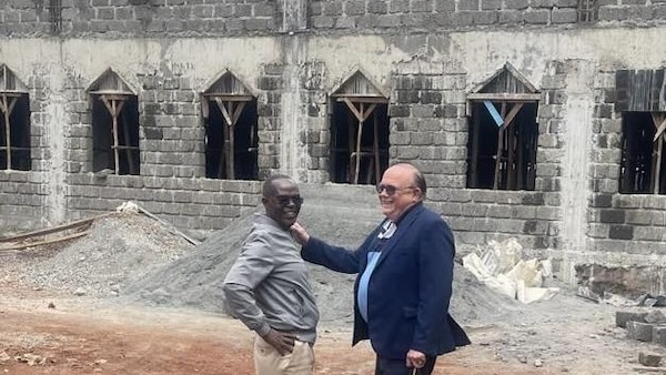 Two men standing in front of a building