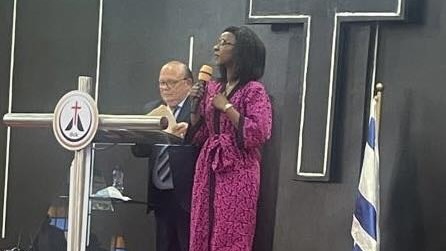 A person in a pink robe holding a microphone