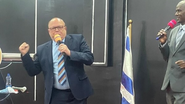 A person in a suit holding a microphone