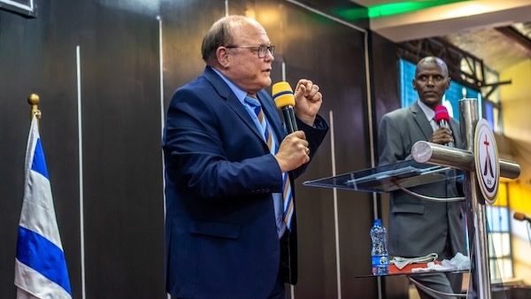 A person in a suit holding a microphone