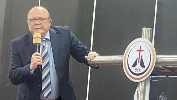 A person in a suit holding a microphone