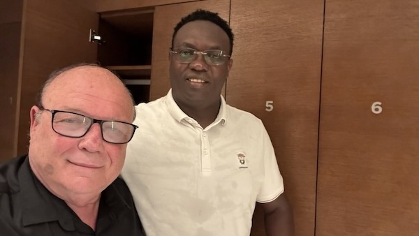 Two men standing in front of a closet