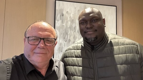 Two men standing together smiling