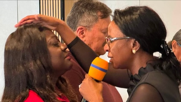 Dr. Adalia praying over people