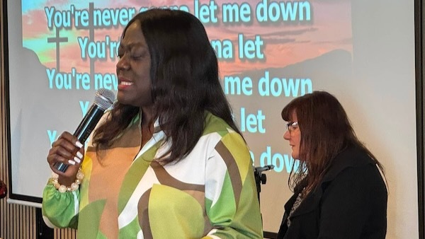 Pastor Theodora Bessem leading worship