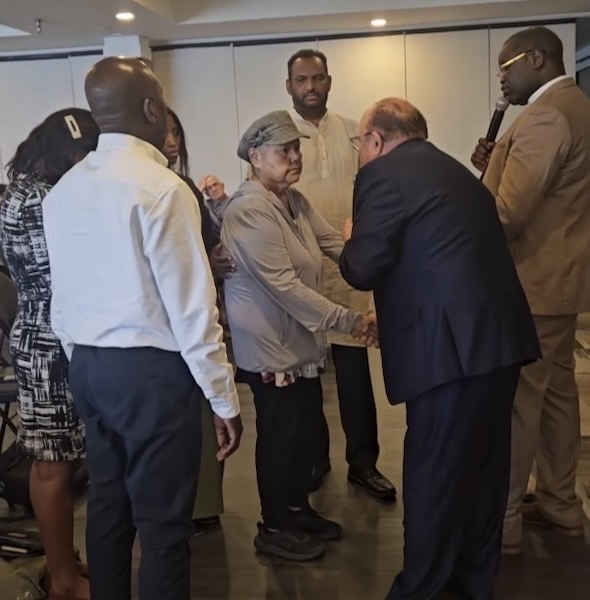 Dr. Hansen praying over a person with cancer